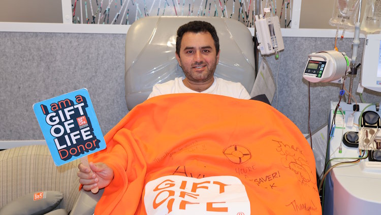 Gift of Life stem cell donor Avi is shown in the stem cell collection center during the apheresis process. His stem cells will give a woman diagnosed with leukemia her best chance for a cure.