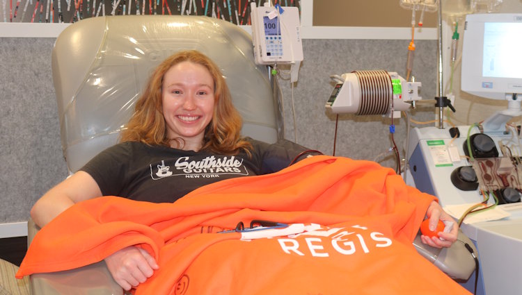 Gift of Life stem cell donor Emma is in the collection center donating cells to help save a woman diagnosed with blood cancer. Emma has a huge smile and is excited to be helping someone in need.