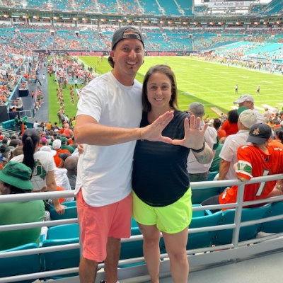 Gift of Life stem cell donor Alyssa (r) with her husband Clint at a University of Miami football game. They came to South Florida so Alyssa could donate stem cells to her matching recipient, a 40-year-old man battling leukemia. While preparing for donation, the two took advantage of their "donation vacation" to attend sporting events and explore the area's restaurants and attractions. 