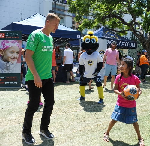 LA Galaxy goalkeeper Jon Kempin plays soccer with kids at Gift of Life's Kick Blood Cancer event in Los Angeles.