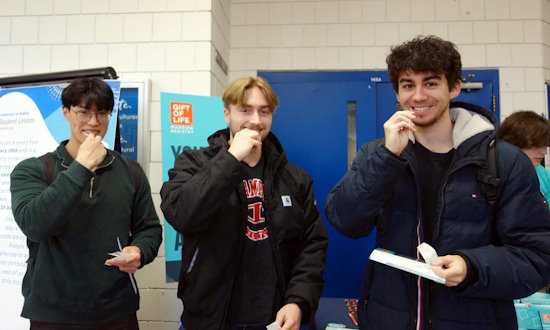 Three male college students are shown swabbing their cheeks to join Gift of Life's stem cell registry. The drive, held at the University at Buffalo, was organized by Gift of Life Campus Ambassadors and the campus's Hillel chapter. 