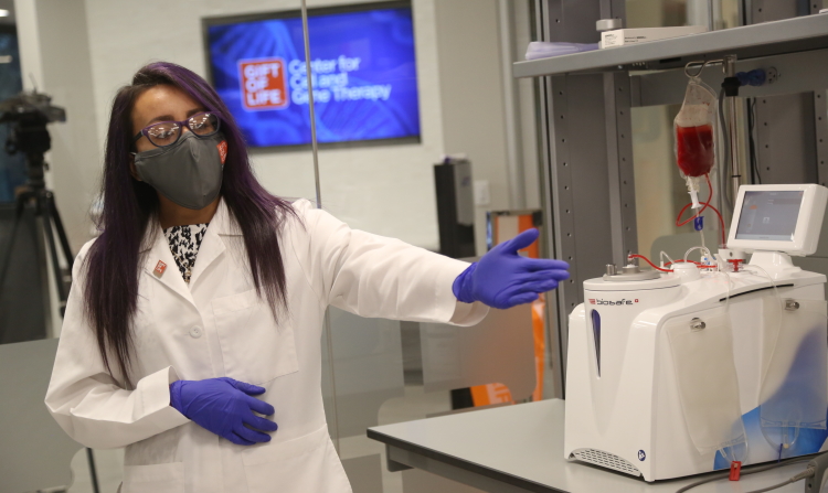 Andrea Pena, Senior BioBank Cell Processing Specialist, demonstrates cell processing equipment at the Gift of Life Center for Cell and Gene Therapy.