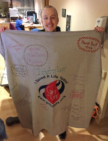 Christopher Mattson on donation day with his Gift of Life blanket signed with thanks from the organization's staff members.