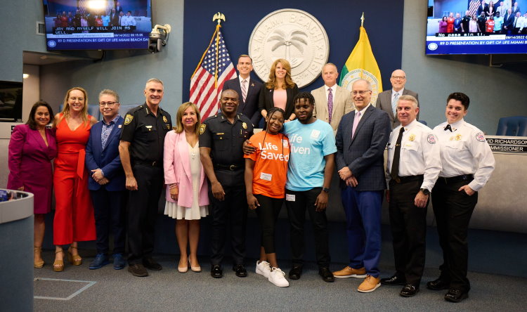 Miami Beach Mayor Dan Gelber, the City Commissioners, and representatives from the Police and Fire Departments, celebrate "Gift of Life Marrow Registry Day" by introducing sickle cell survivor Olivia Moseley to her lifesaving marrow donor Brandon Folkes (center).