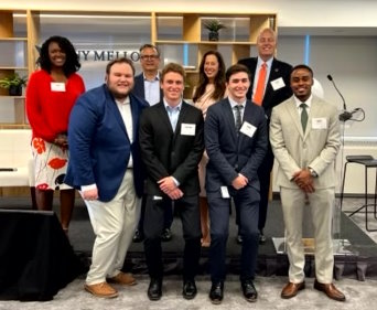 Dante (front row, right) and his winning team with the competition judges. 