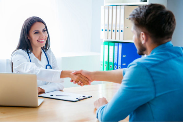 A smiling female doctor is shaking hands across a table with a young man. Both of them are seated.  Learning that you have a matching donor available is an incredible moment of hope. Gift of Life is dedicated to making more of these moments happen for those battling life-threatening diseases.