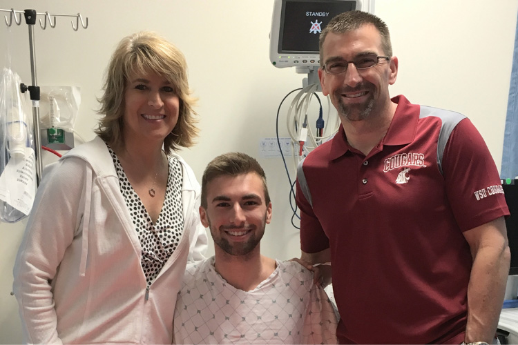 Aaron, a young man in his early 20s, has just donated bone marrow and sits with his parents on either side of him. All are smiling and look proud and excited. Bone marrow donation With Gift of Life takes 1-2 hours, and is an outpatient process.